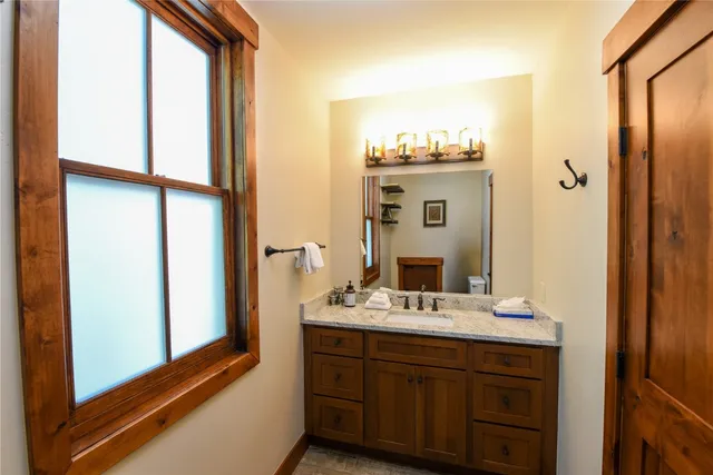 a bathroom with a double vanity sink mirror and