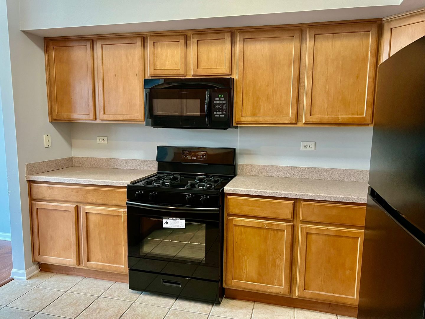 2328 Georgetown Circle Aurora, IL 60503 - Photo 5 of 12 a kitchen with wooden cabinets and a stove top oven