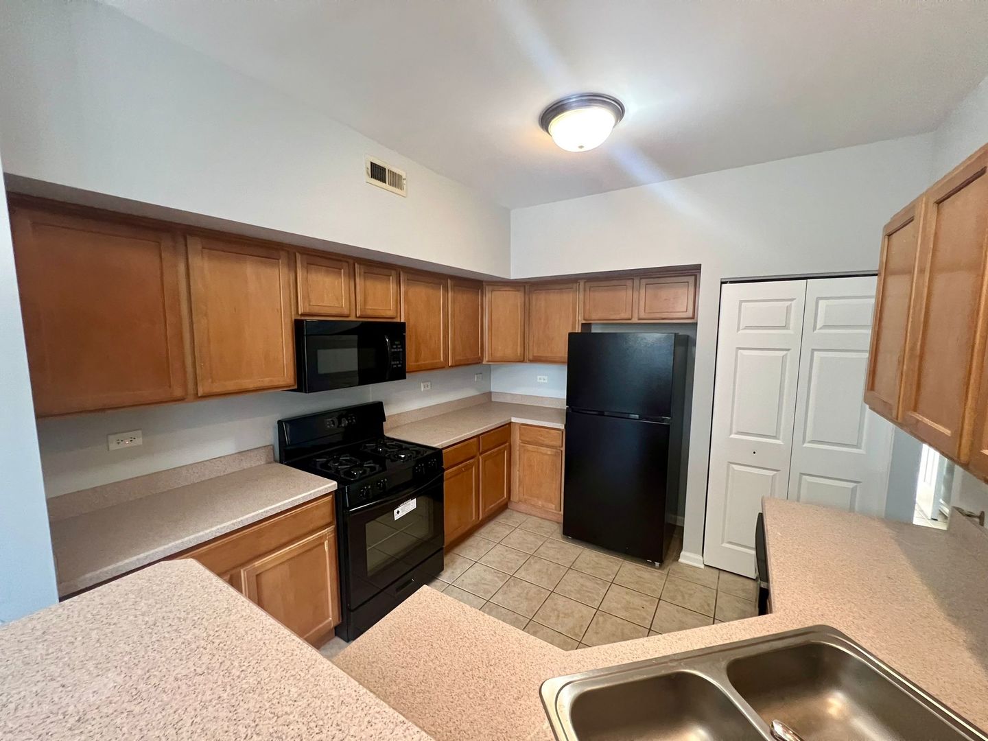2328 Georgetown Circle Aurora, IL 60503 - Photo 6 of 12 a kitchen with a refrigerator and a sink