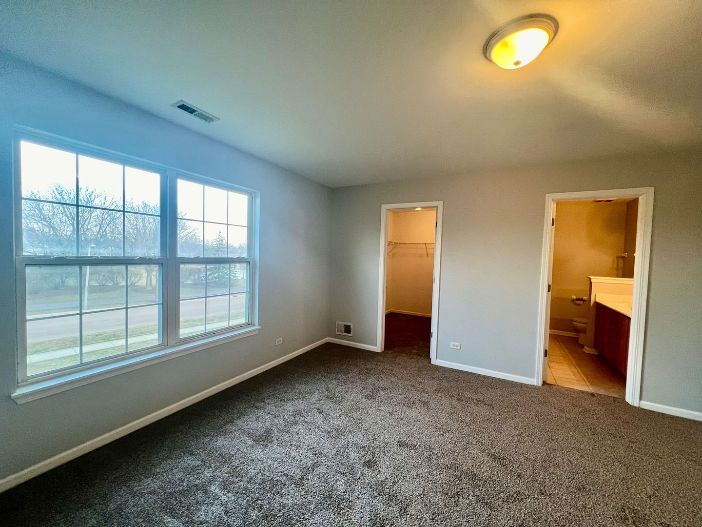 2328 Georgetown Circle Aurora, IL 60503 - Photo 7 of 12 an empty room with windows and closet