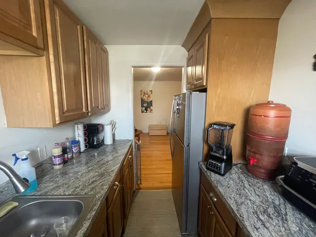 a kitchen with sink refrigerator and cabinets