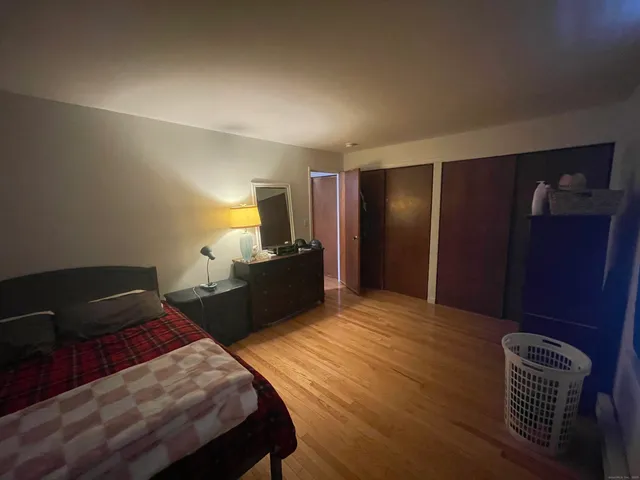 a bedroom with a bed and a closet