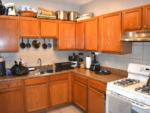 a kitchen with stainless steel appliances granite countertop a sink stove and cabinets