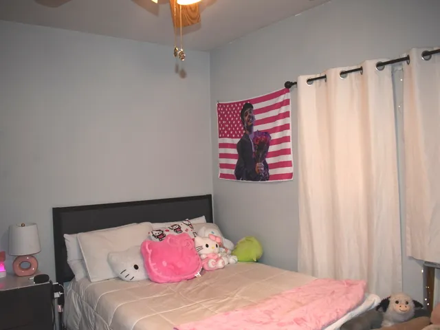 a bedroom with a bed and a mirror