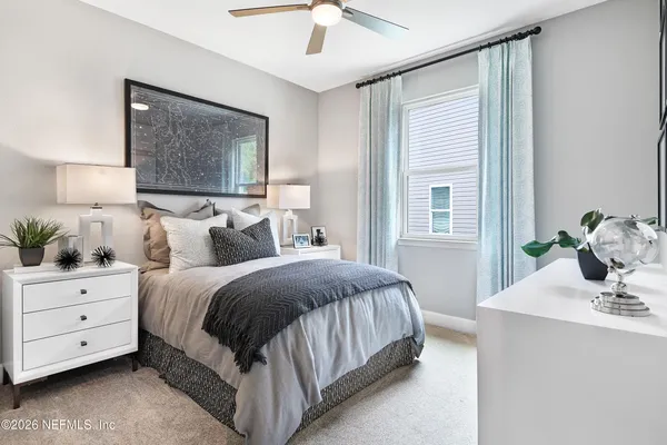 a bedroom with a bed and a window