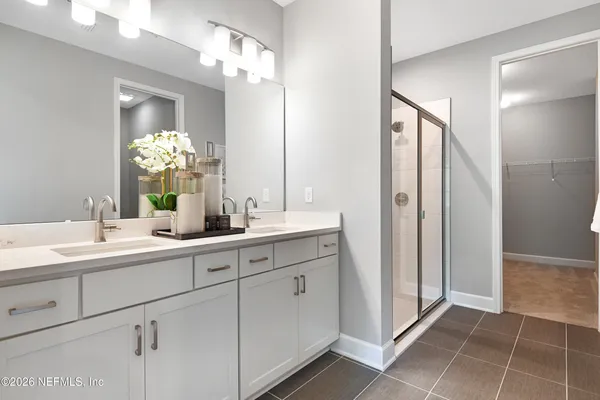 a bathroom with a double vanity sink and a mirror