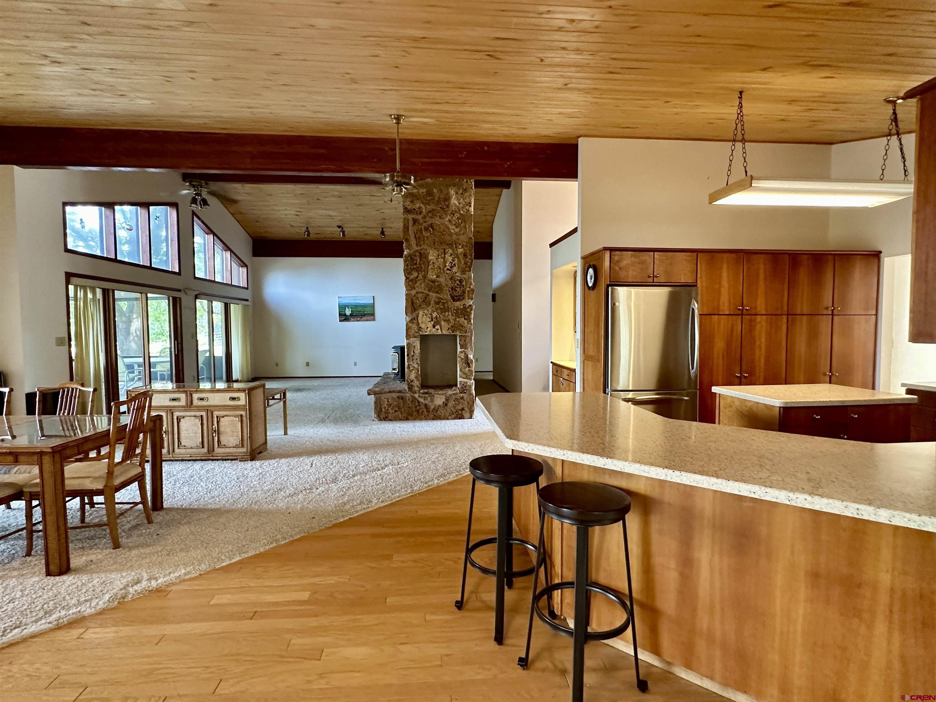 14581 Deer Run Road Delta, CO 81416 - Photo 11 of 35 a living room with stainless steel appliances kitchen island granite countertop furniture and a large window