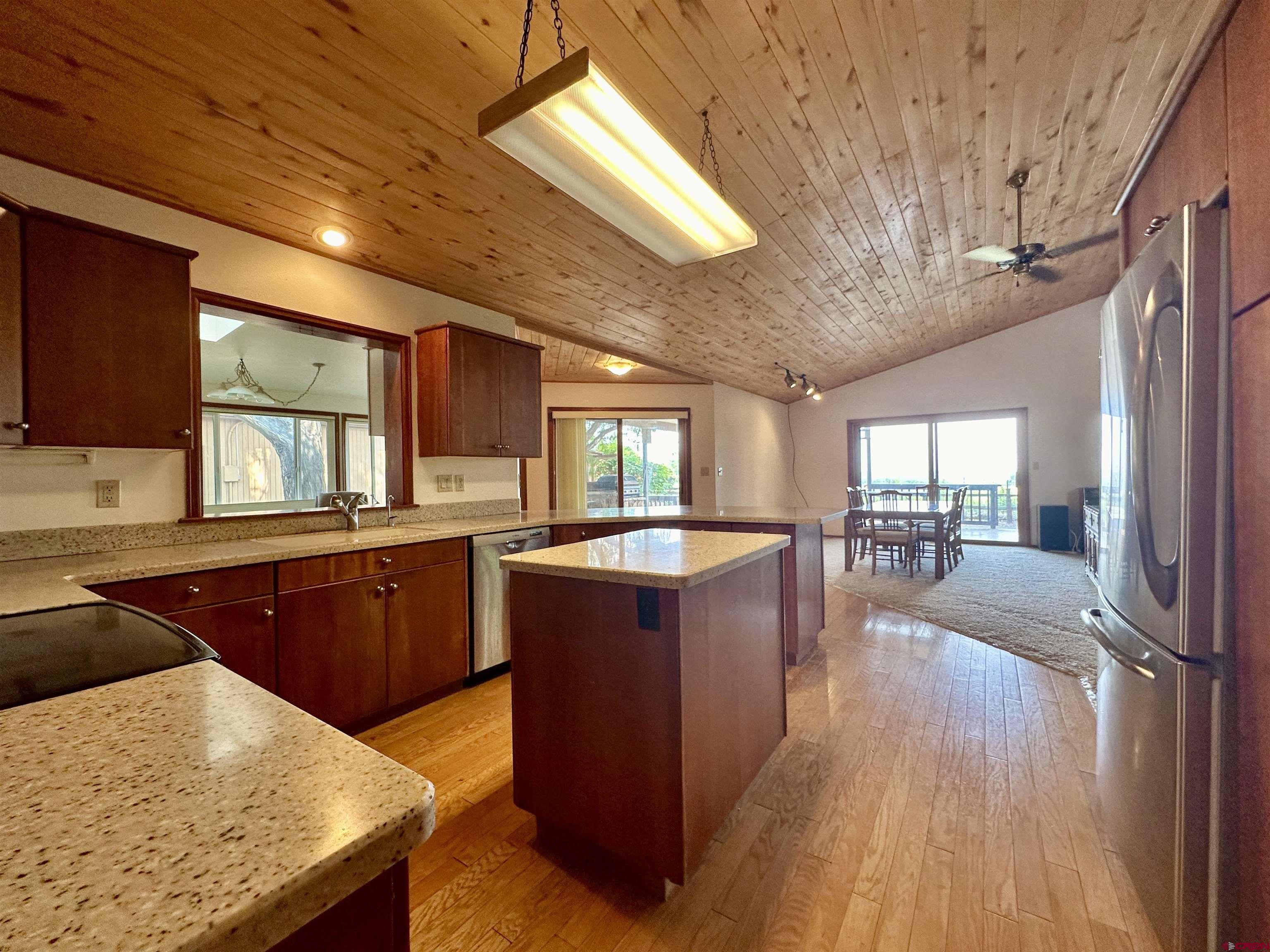 14581 Deer Run Road Delta, CO 81416 - Photo 14 of 35 a kitchen with wooden floors and wooden cabinets