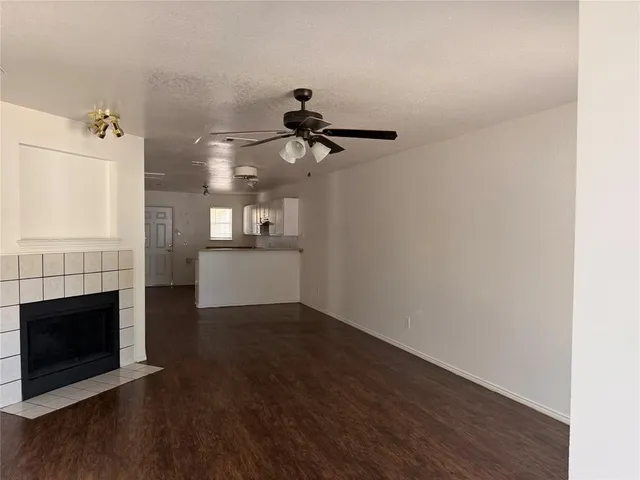 a view of a kitchen with a sink a fireplace and wooden floor