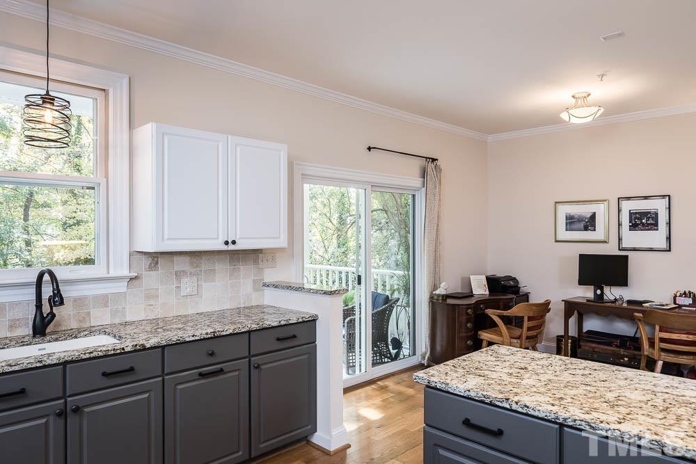 100 Edenburgh Road, Unit 203 Raleigh, NC 27608 - Photo 12 of 26 a kitchen with granite countertop kitchen island sink stove and view living room