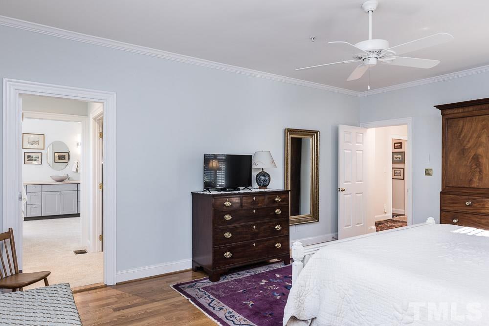 100 Edenburgh Road, Unit 203 Raleigh, NC 27608 - Photo 19 of 26 a bedroom with a bed and a television