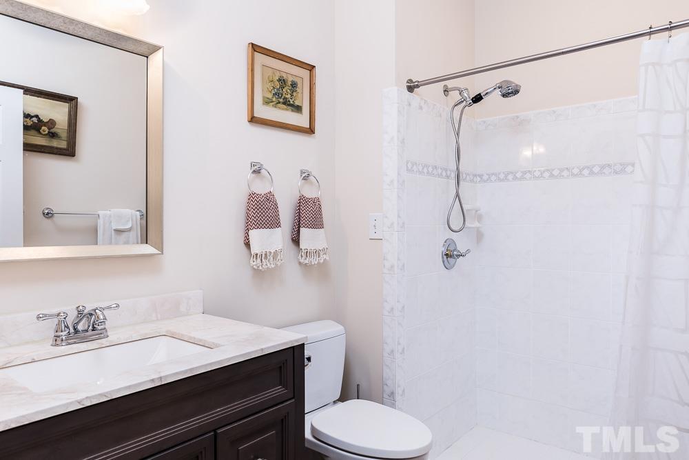 100 Edenburgh Road, Unit 203 Raleigh, NC 27608 - Photo 24 of 26 a bathroom with a granite countertop sink toilet and shower