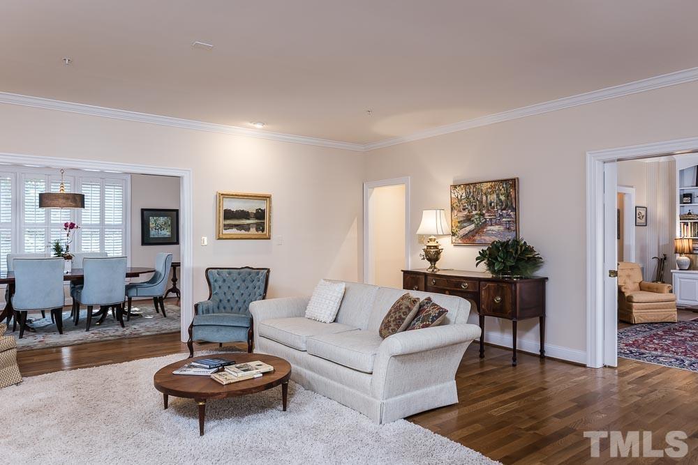 100 Edenburgh Road, Unit 203 Raleigh, NC 27608 - Photo 5 of 26 a living room with furniture a rug and a table