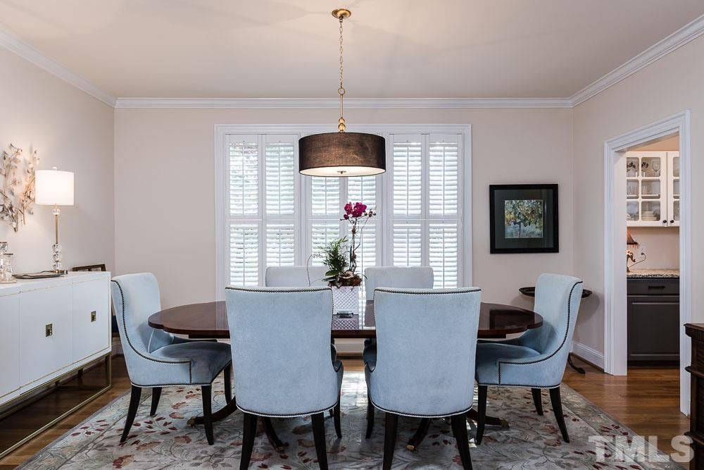 100 Edenburgh Road, Unit 203 Raleigh, NC 27608 - Photo 7 of 26 a view of a dining room with furniture window and wooden floor
