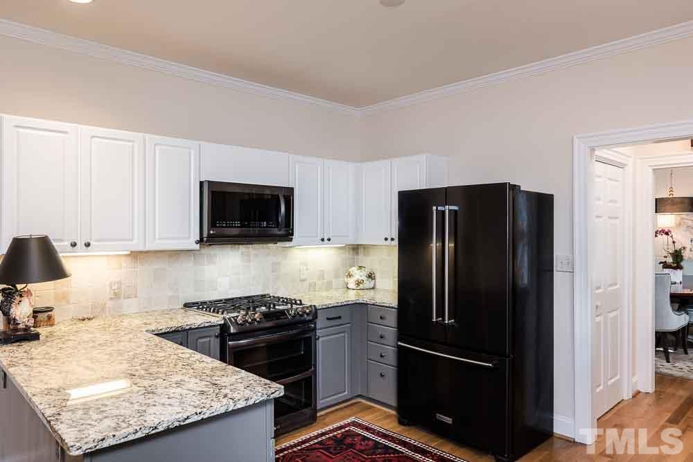 100 Edenburgh Road, Unit 203 Raleigh, NC 27608 - Photo 9 of 26 a kitchen with a stove microwave and refrigerator