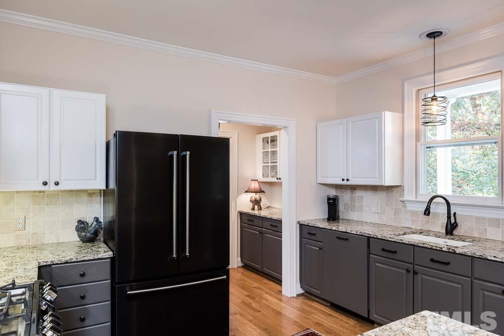 100 Edenburgh Road, Unit 203 Raleigh, NC 27608 - Photo 10 of 26 a kitchen with a refrigerator and a sink