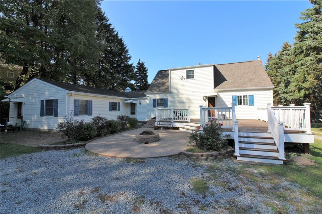Rear view.  Large rear deck.  Fire pit.  Separate entrance for in-law suite.  