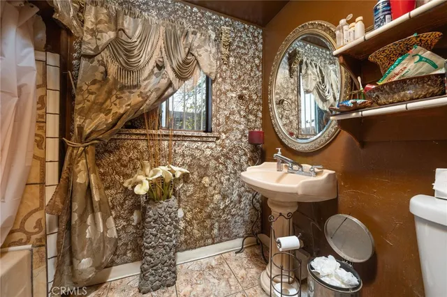 a bathroom with a sink mirror and toilet