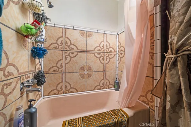 a bathroom with a bathtub and shower