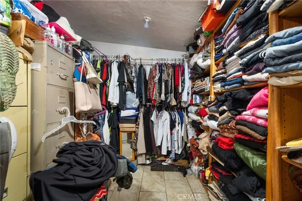 a view of walk in closet with clothes