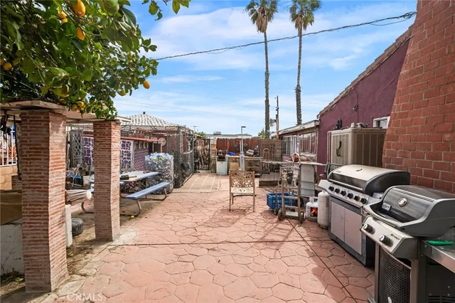 a view of a patio with chairs and potted plants