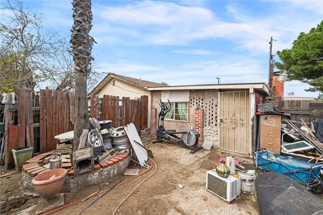 a view of a patio with table and chairs and potted plants