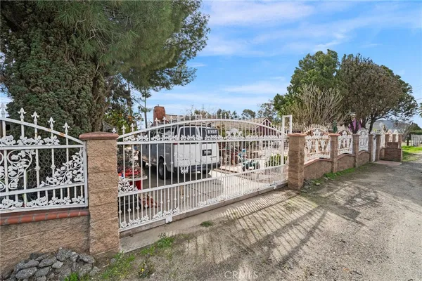 a view of a house with a small yard and wooden fence