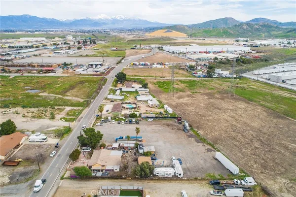 an aerial view of residential houses with outdoor space and street view