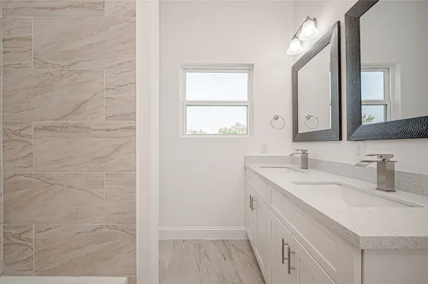 a bathroom with a sink a vanity and a mirror