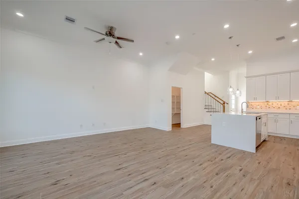 a view of kitchen and hall with wooden floor