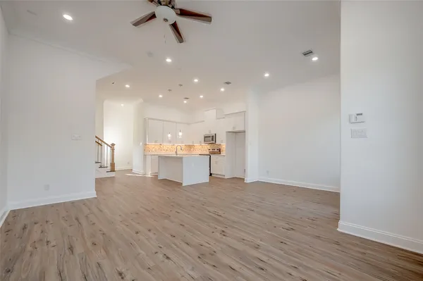 a view of a kitchen with a sink and wooden floor