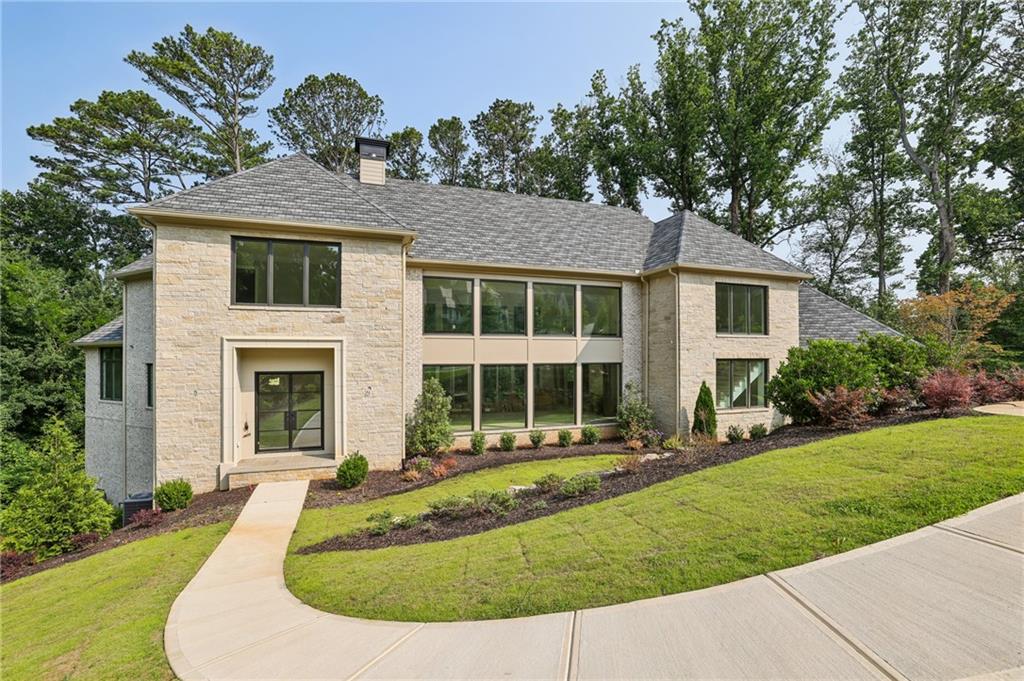 825 Kenry Court Atlanta, GA 30342 - Photo 1 of 50 a front view of a house with a yard