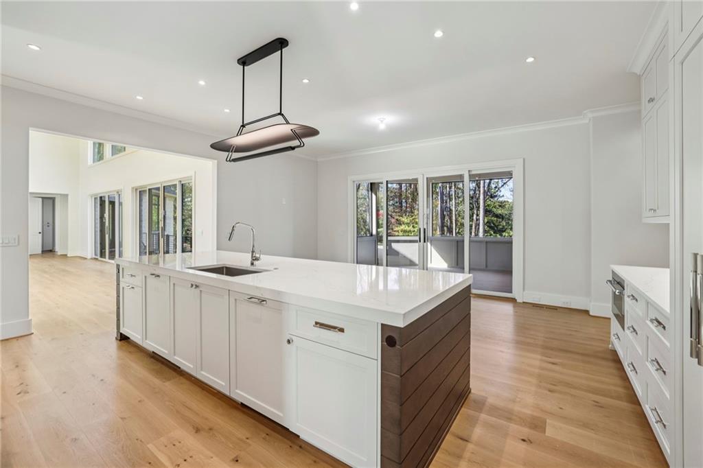 825 Kenry Court Atlanta, GA 30342 - Photo 12 of 50 a kitchen with granite countertop a sink and a stove top oven