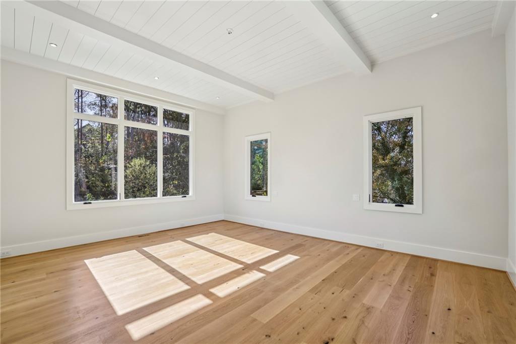 825 Kenry Court Atlanta, GA 30342 - Photo 18 of 50 a view of an empty room with wooden floor and a window