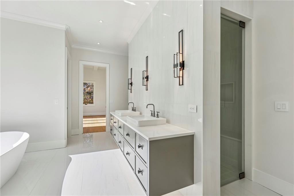 825 Kenry Court Atlanta, GA 30342 - Photo 22 of 50 a spacious bathroom with a sink a toilet a shower and a mirror