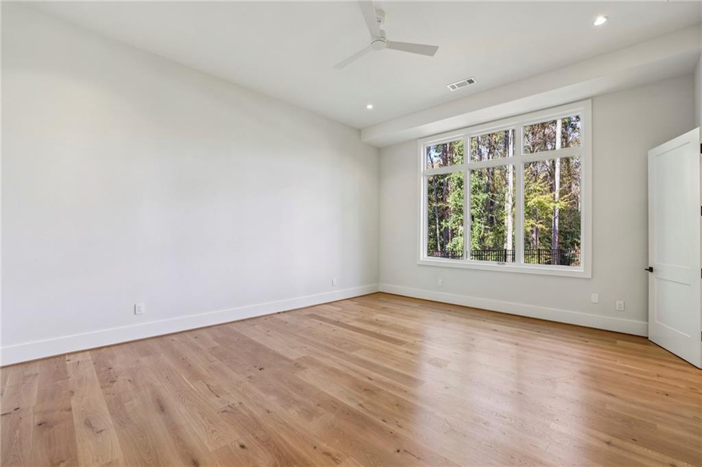 825 Kenry Court Atlanta, GA 30342 - Photo 31 of 50 an empty room with wooden floor and windows
