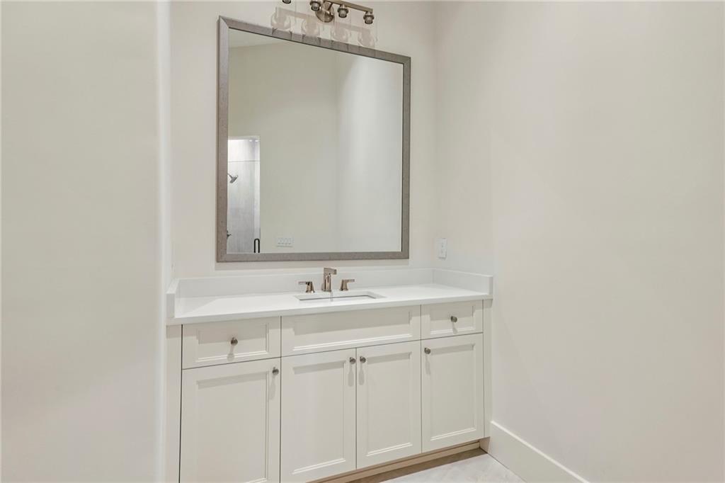 825 Kenry Court Atlanta, GA 30342 - Photo 33 of 50 a bathroom with a sink and a mirror