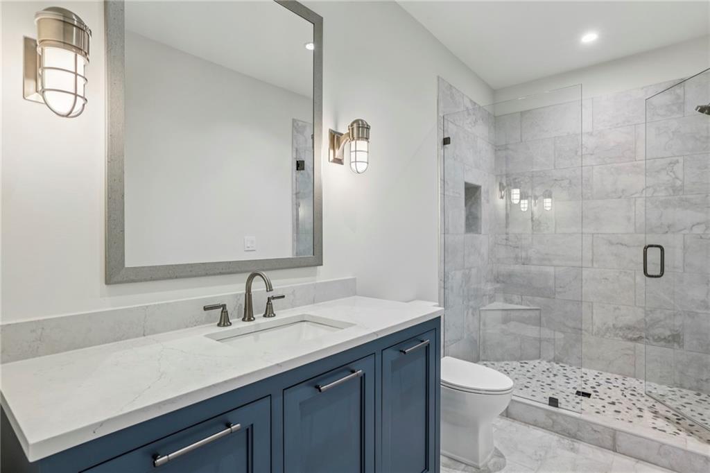 825 Kenry Court Atlanta, GA 30342 - Photo 48 of 50 a bathroom with a sink a toilet and shower