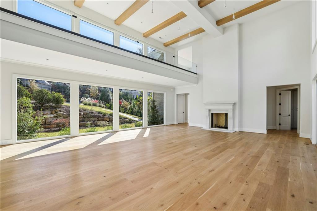 825 Kenry Court Atlanta, GA 30342 - Photo 6 of 50 a view of an empty room with wooden floor and a window