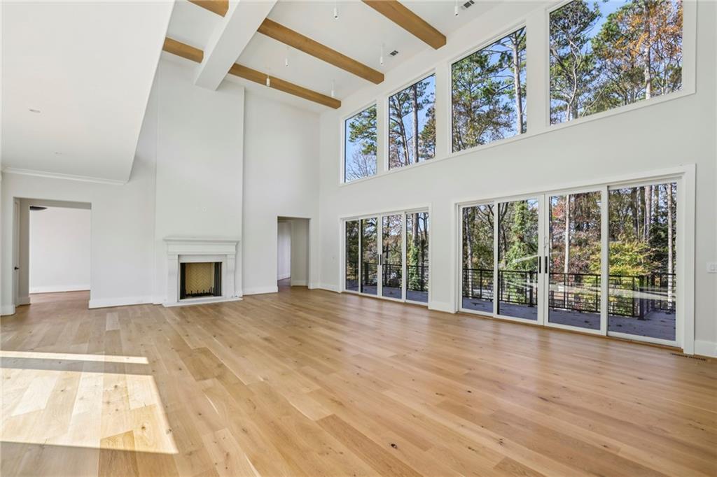 825 Kenry Court Atlanta, GA 30342 - Photo 7 of 50 a view of an empty room with wooden floor and a fireplace