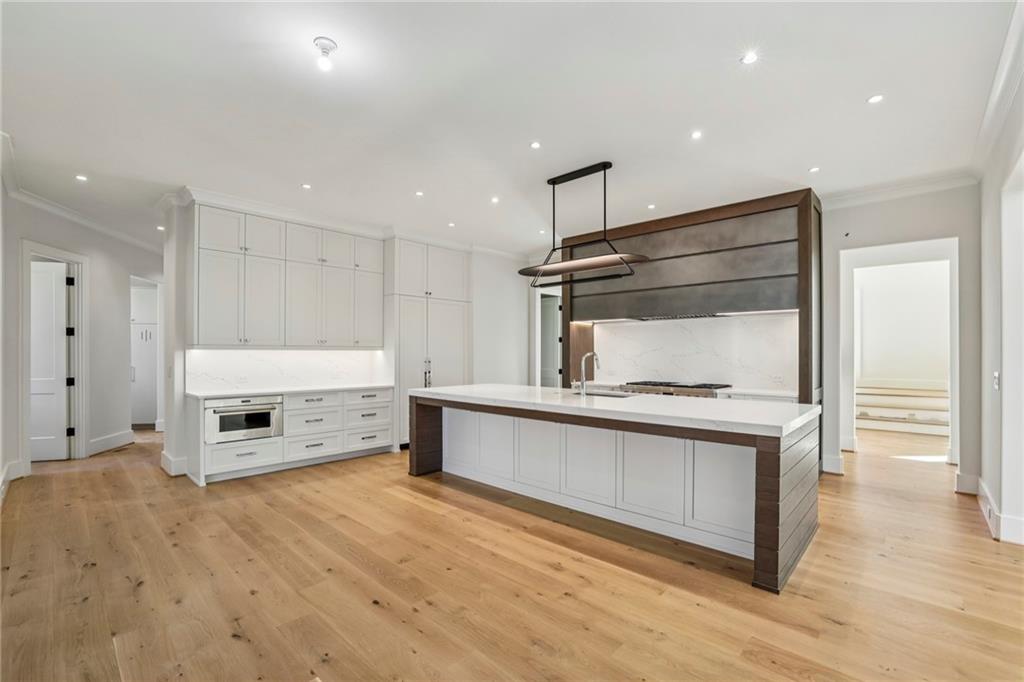 825 Kenry Court Atlanta, GA 30342 - Photo 8 of 50 a kitchen with a refrigerator and white cabinets