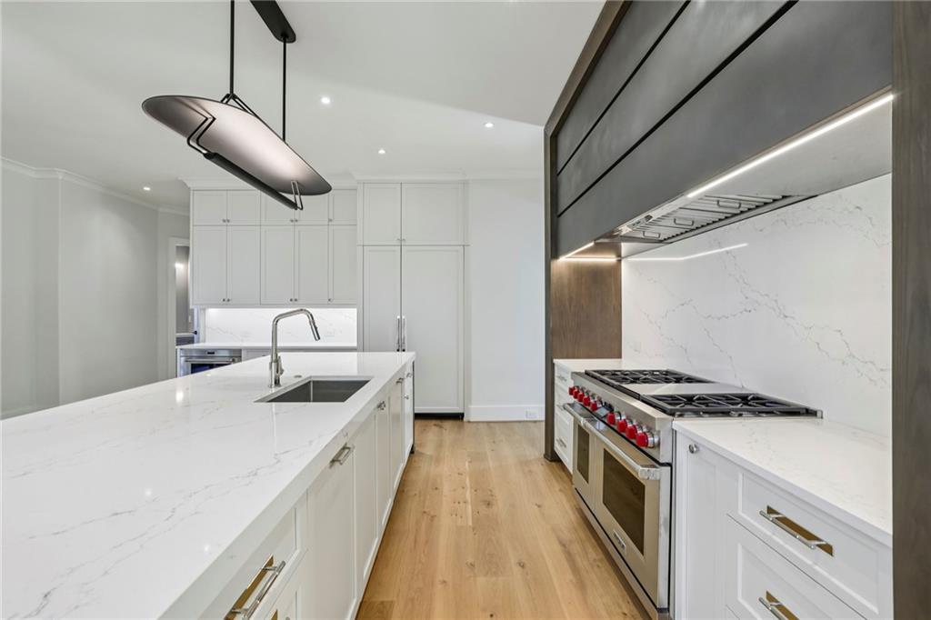 825 Kenry Court Atlanta, GA 30342 - Photo 10 of 50 a kitchen with stainless steel appliances granite countertop a sink a stove and a refrigerator