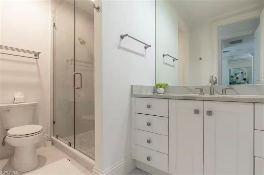 428 Rudder Road Naples, FL 34102 - Photo 31 of 47 Full bath featuring vanity, a shower stall, and light tile patterned flooring