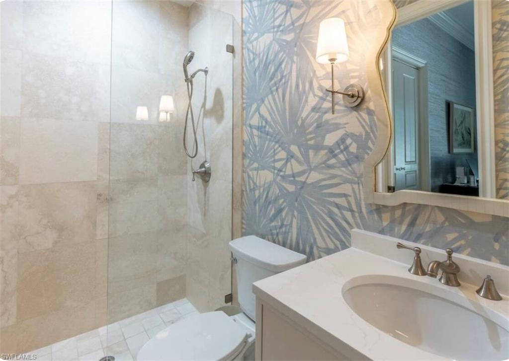 428 Rudder Road Naples, FL 34102 - Photo 32 of 47 Bathroom featuring wallpapered walls, a walk in shower, vanity, and connected bathroom