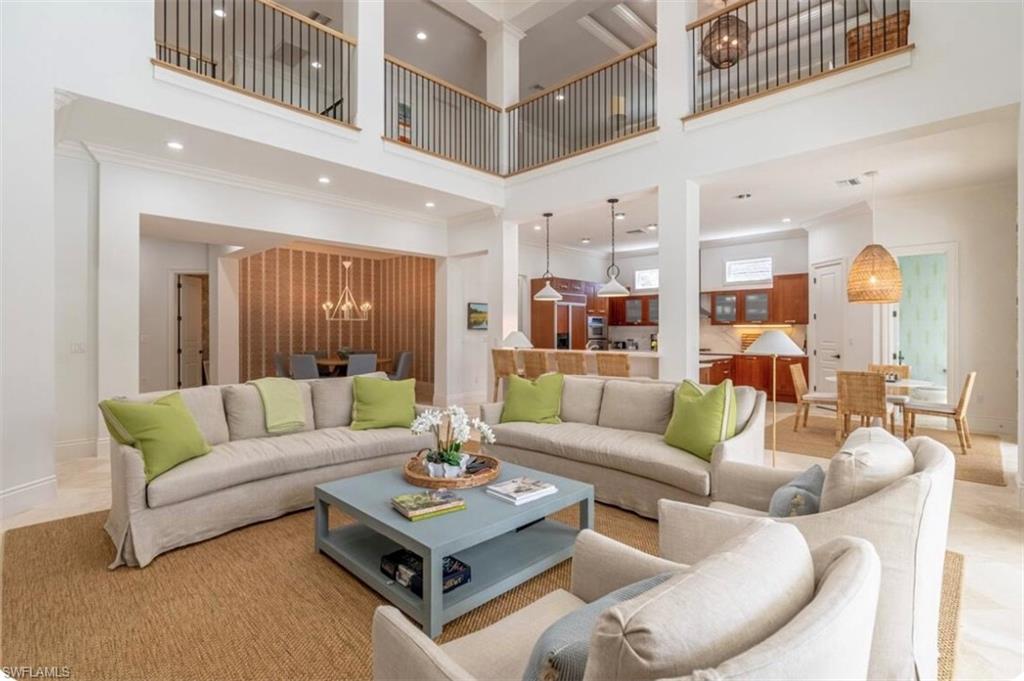 428 Rudder Road Naples, FL 34102 - Photo 44 of 47 Living area featuring a chandelier, a high ceiling, recessed lighting, and ornamental molding