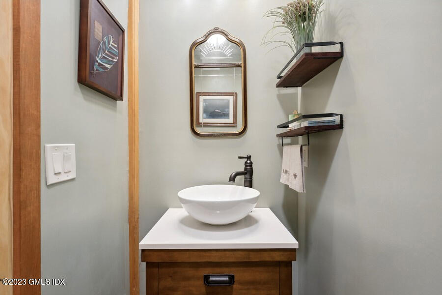 96 Cat Rock Road Cos Cob, CT 06807 - Photo 11 of 38 a bathroom with a toilet a sink and mirror