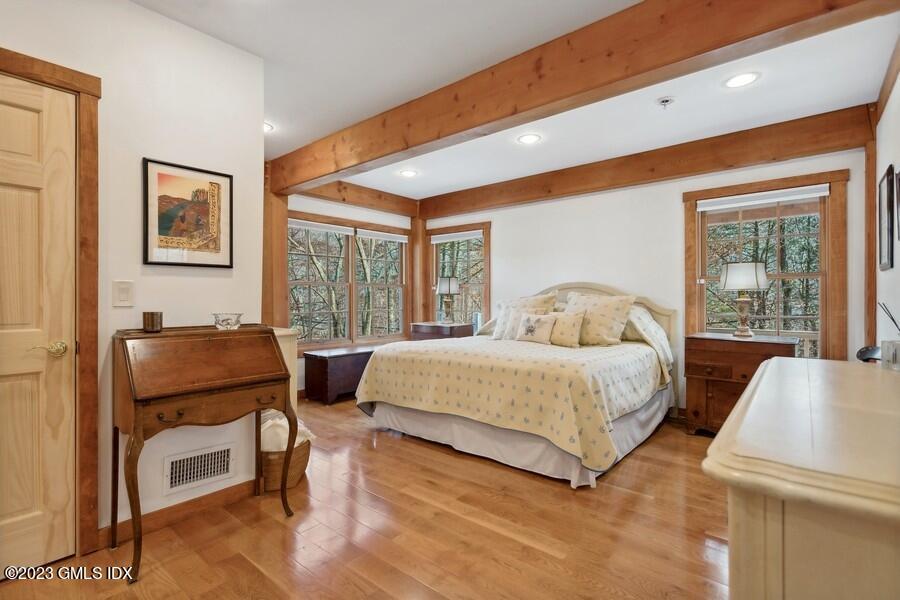 96 Cat Rock Road Cos Cob, CT 06807 - Photo 12 of 38 a bedroom with a bed and a dresser next to a window