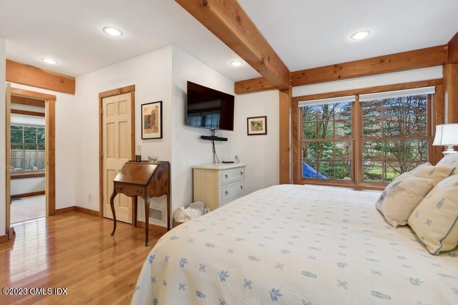 96 Cat Rock Road Cos Cob, CT 06807 - Photo 13 of 38 a spacious bedroom with a bed and a flat screen tv