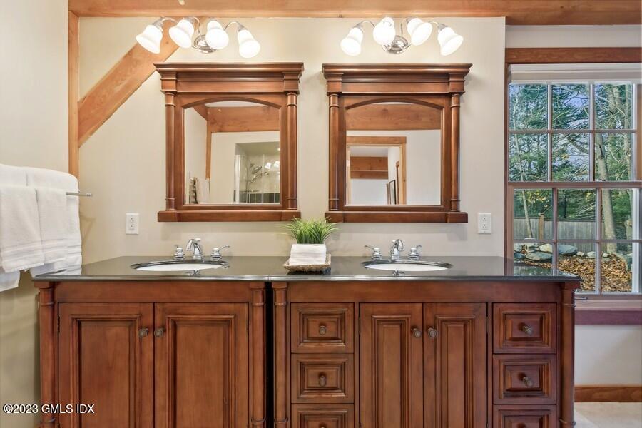 96 Cat Rock Road Cos Cob, CT 06807 - Photo 15 of 38 a bathroom with a granite countertop sink a large mirror and a window