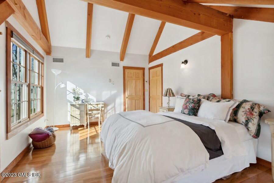 96 Cat Rock Road Cos Cob, CT 06807 - Photo 19 of 38 a bedroom with a bed and wooden floor